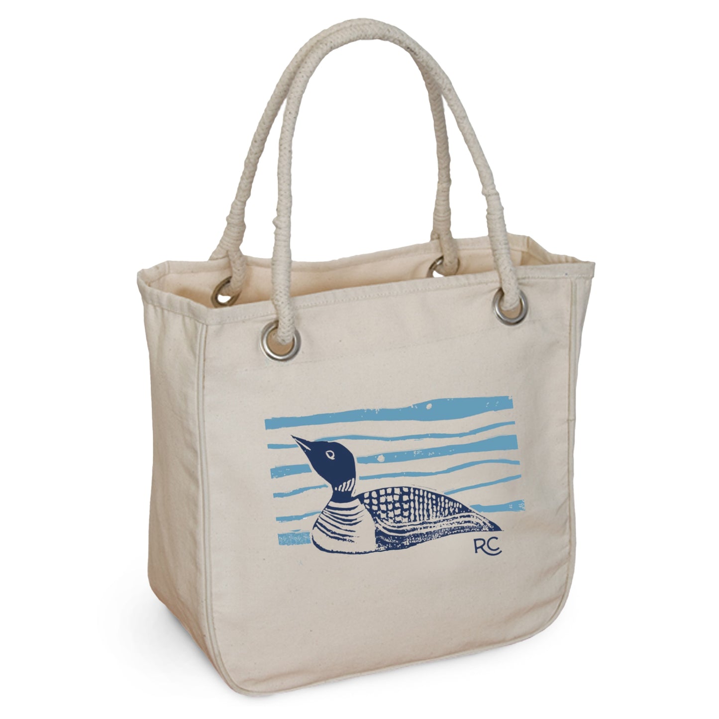 The Maine Loon on the Lake Rope Tote by Rustic County is made of organic beige canvas with rope handles and displays a blue and black loon on light blue water lines. The initials "RC" in the bottom right add to its eco-friendly coastal charm.