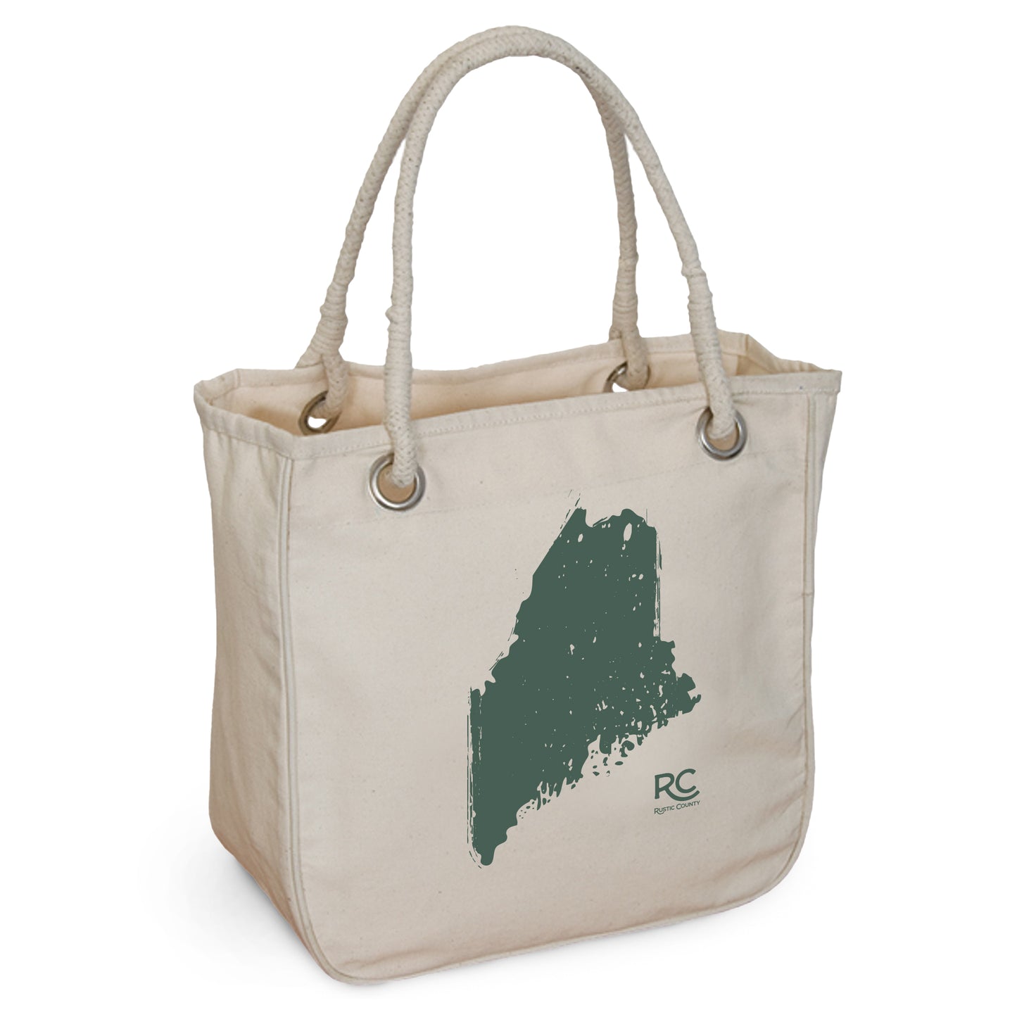 A beige organic cotton Maine Rope Tote from Rustic County with sturdy rope handles and a green brushstroke map of Maine imprinted on one side, along with the initials "RC" in a lower corner.
