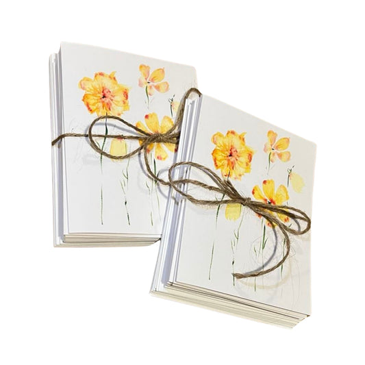 The Rustic County Watercolor Prints Note Card Bundle includes two sets of assorted note cards with yellow and orange watercolor designs, crafted on premium paper and tied with brown twine, shown on a white background.