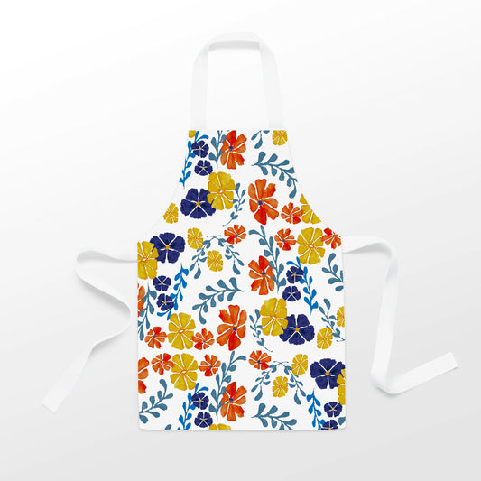 Introducing the Flowers in Bloom Apron from Rustic County, a stunning white apron adorned with vibrant floral patterns featuring orange, yellow, blue, and red flowers accompanied by lush green leaves. This wearable piece of art is complete with white straps for tying around the neck and waist. Enjoy exclusive artwork that brightens your culinary adventures!