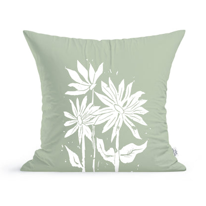 A light green Sunflowers Pillow by Rustic County featuring a white sunflower print design with three stylized flowers and leaves.