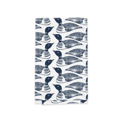 A Maine Loon Pattern Kitchen Tea Towel from Rustic County with a repeating pattern of stylized blue and white fish against a white background. The fish designs are artistic with prominent eyes and textured scales.