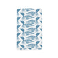 Sentence with replaced product name and brand name: A Maine Loon Pattern Kitchen Tea Towel from Rustic County, with a repetitive pattern of blue stylized fish against a white background, designed with intricate line details on their bodies, perfect for kitchen decor.