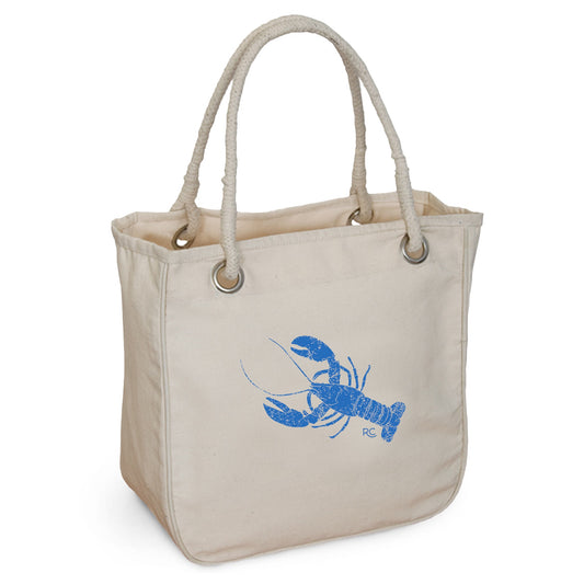 The Blue Lobster Rope Tote by Rustic County features a blue lobster graphic on beige organic cotton with sturdy rope handles—an ideal, stylish bag for beach trips or everyday use.