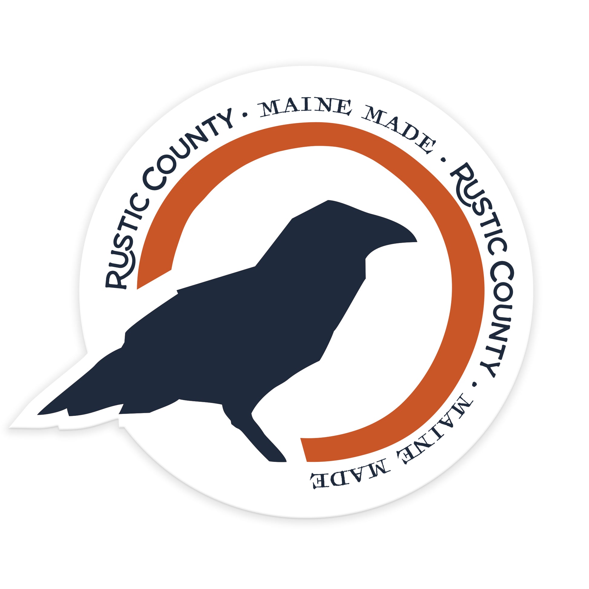 Round sticker featuring a silhouette of a crow at its center with text "Rustic County - Maine Made" encircling it in orange and navy blue, crafted as a die-cut logo sticker.